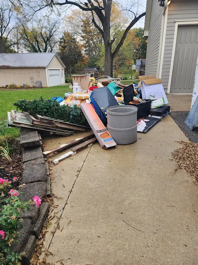 Dumpster being loaded with debris for Residential Dumpster Rental in Des Peres